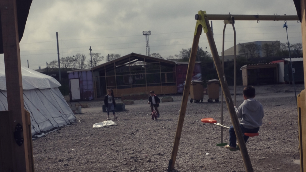 The view from the new semi-permanent school buildings on to the main thoroughfare through Liniere [Jasper Clarke/Al Jazeera]