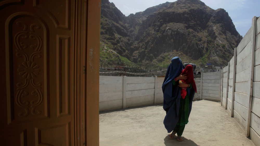 A woman coming from Afghanistan enters the information centre at the border post in Torkham, Pakistan [REUTERS]