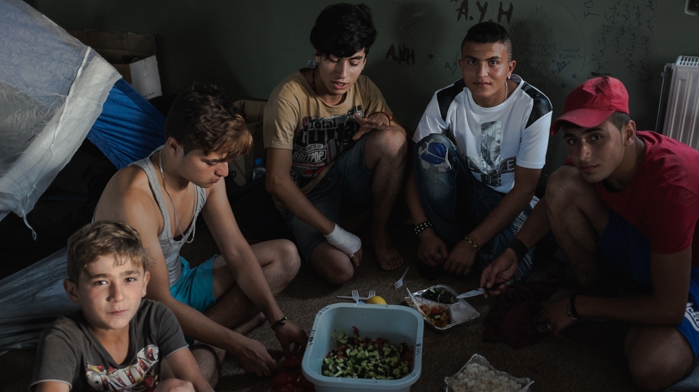 A Syrian family breaks the fast during Ramadan, a holy month for Muslims, in the Dipethe camp on Chios [Nick Paleologos/SOOC/Al Jazeera]