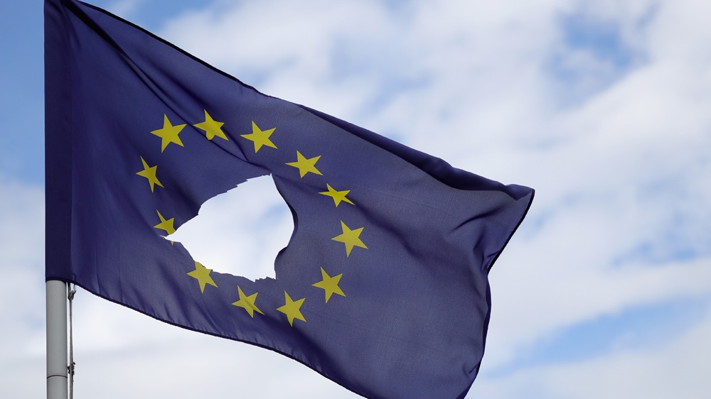 A European Union flag, with a hole cut in the middle