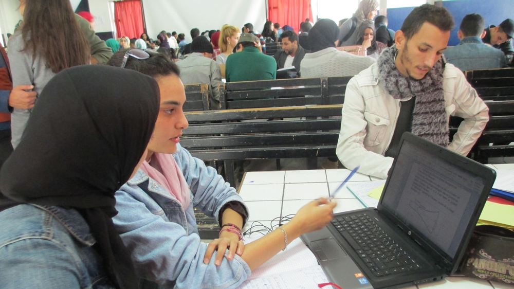 Students are studying for chemistry exams in the science library of Hassan II University in Casablanca. The library doesn't have any books, only rows of tables [Jennifer Kwon/Al Jazeera]