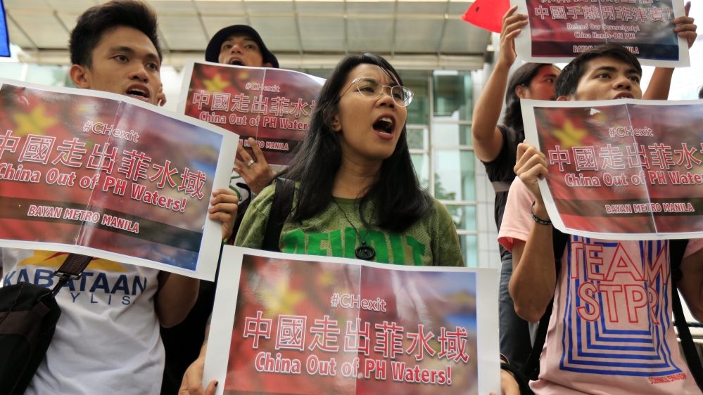 Filipinos stage a demonstration in front of the Chinese consular office in Makati
