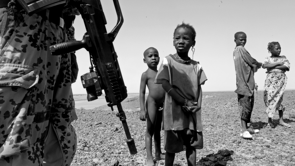 
The peacekeepers talk to children during the patrol [ Marielle van Uitert/Al Jazeera]  
