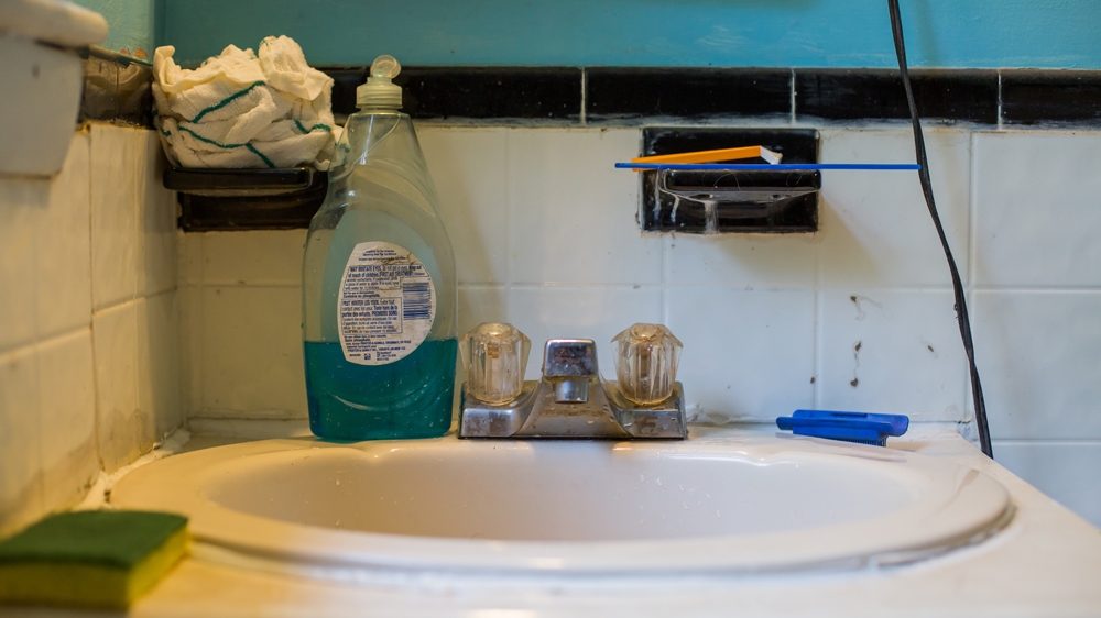  Scott's motel bathroom may be a little messy but his room is clean and tidy  [Carolyn Bick/Al Jazeera] 