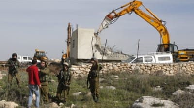 A Palestinian man argues with Israeli soldiers during the demolition of a Palestinian house [Reuters]