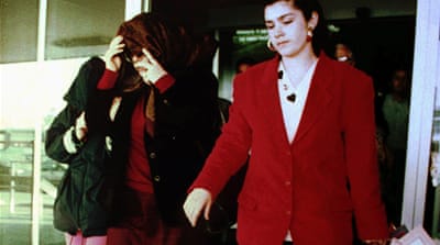 Antonietta Bagarella Riina, left, wife of 'Toto' Riina, covers her face as she leaves a shop in Corleone, in the hills outside Palermo, accompanied by her daughters, in 1995 [Alessandro Fucarini/AP]
