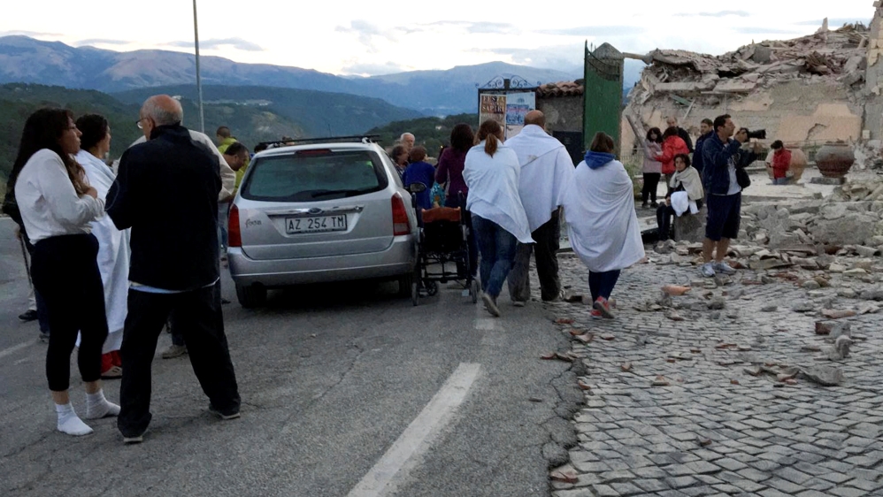 People fled their homes and gathered on the street in Amatrice [Emiliano Grillotti/Reuters]