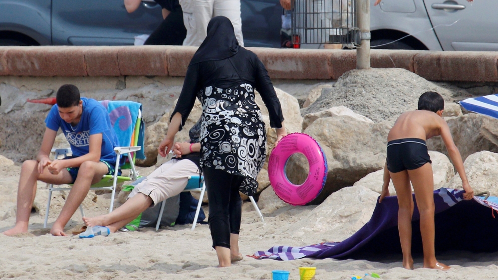 A Muslim woman wears a burkini, a swimsuit that leaves only the face, hands and feet exposed, on a beach in Marseille