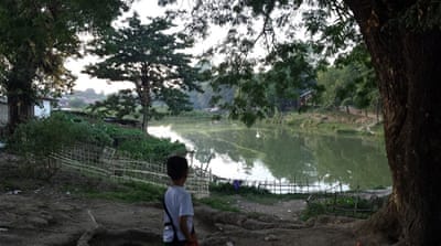 Families rebuilt a bamboo bridge so children could reach a nearby school [Nicola Kelly/Al Jazeera]
