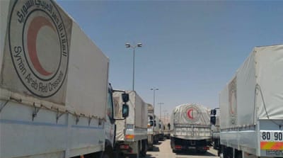 Syrian Arab Red Crescent and Red Cross trucks delivering 37 loaded aid trucks to Zamalka and Erbeen towns in Eastern Ghouta, Syria on June 29 [EPA]