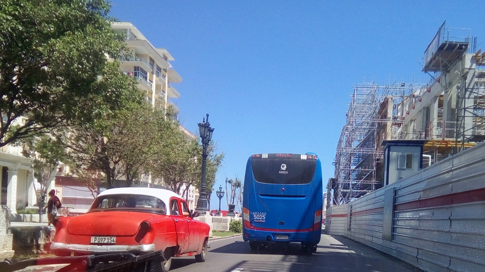 The bus carrying Indian labourers heads back to camp after a day's work [Ed Augustin/Al Jazeera]