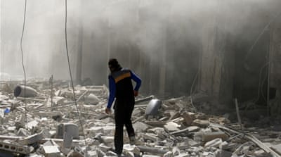 A man walks on the rubble of damaged buildings after an air strike on the rebel held al-Qaterji neighbourhood of Aleppo [Reuters]
