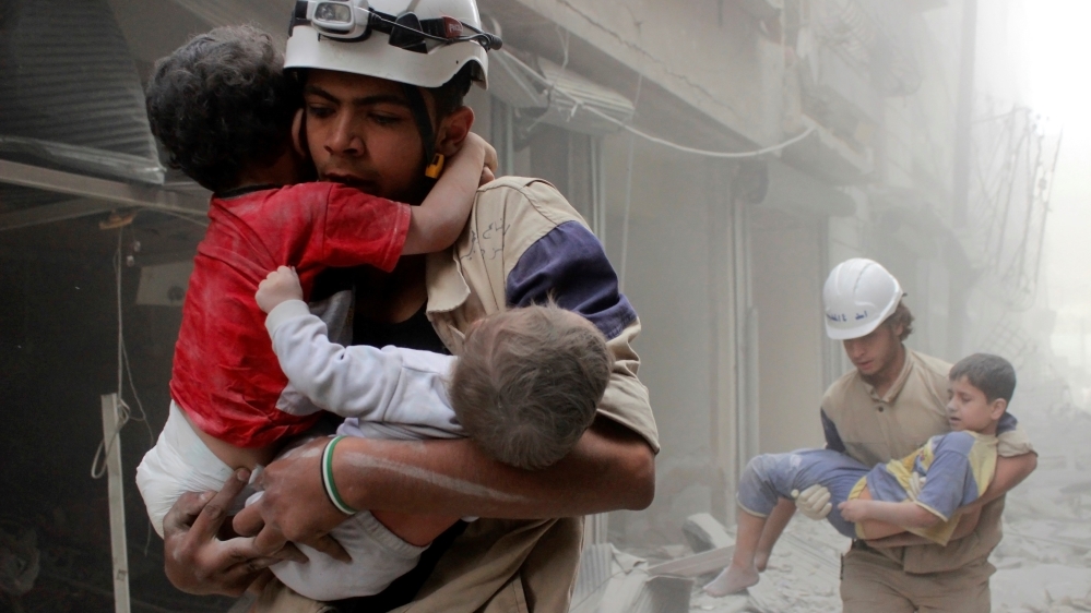 Members of the Civil Defence rescue children after what activists said was an air strike by forces loyal to Syria''s President Assad in al-Shaar neighbourhood of Aleppo