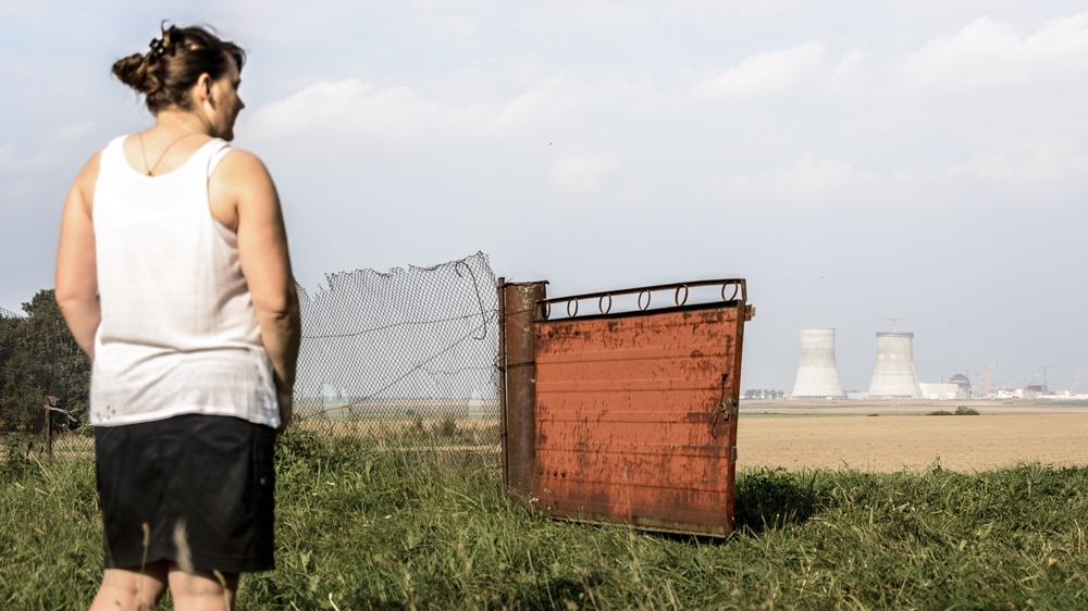 Theresa looks out across the fields towards the nuclear power plant under construction - 'Before it used to be all forest' [ Benas Gerdziunas /Al Jazeera]  