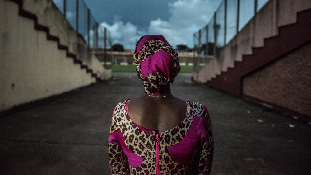 A woman who was abused by the security forces during the September 28th massacre revisits the stadium for the first time [Tommy Trenchard/Al Jazeera] 