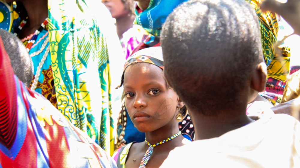 Refugee women and children wait to receive check ups from aid worker with Doctors Without Borders [Lucas Desrtrijcker/Al Jazeera] 