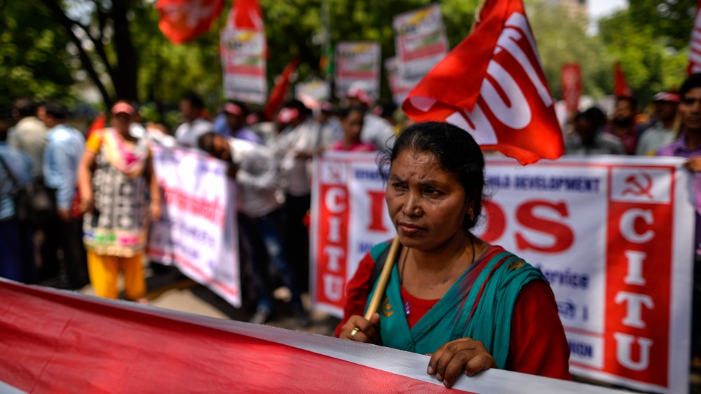 More than 20 protesters were arrested after they damaged two government buses in West Bengal [Chandan Khanna/AFP]