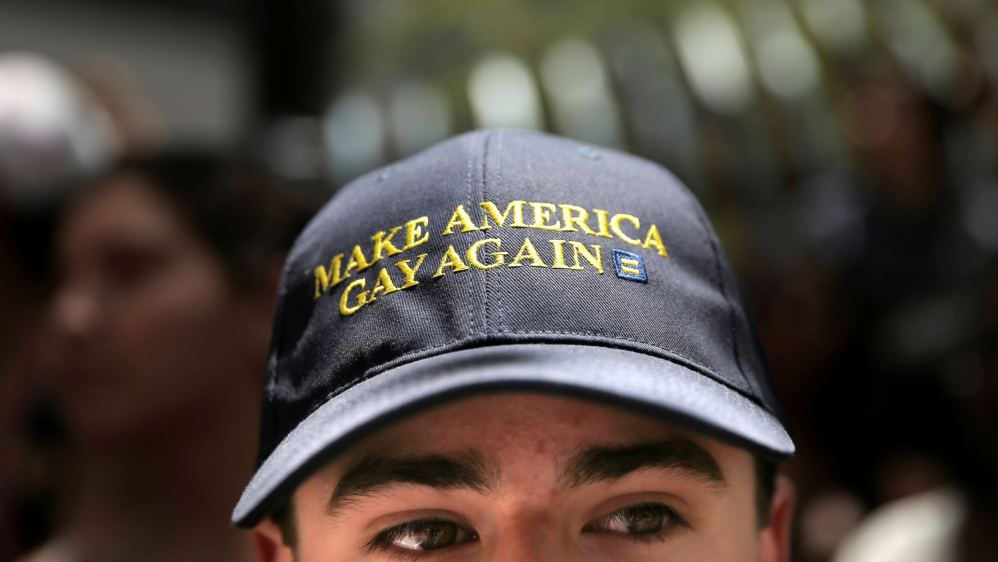 A man wears a hat that says "Make America Gay Again," at San Francisco LGBT Pride Parade in San Francisco, California
