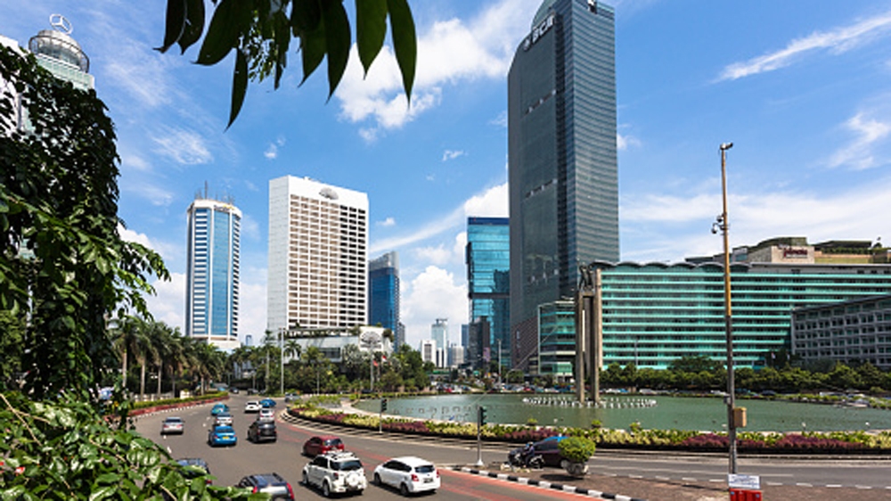 Cars rush through the business district along the Sudirman avenue in Jakarta, Indonesia [Getty]