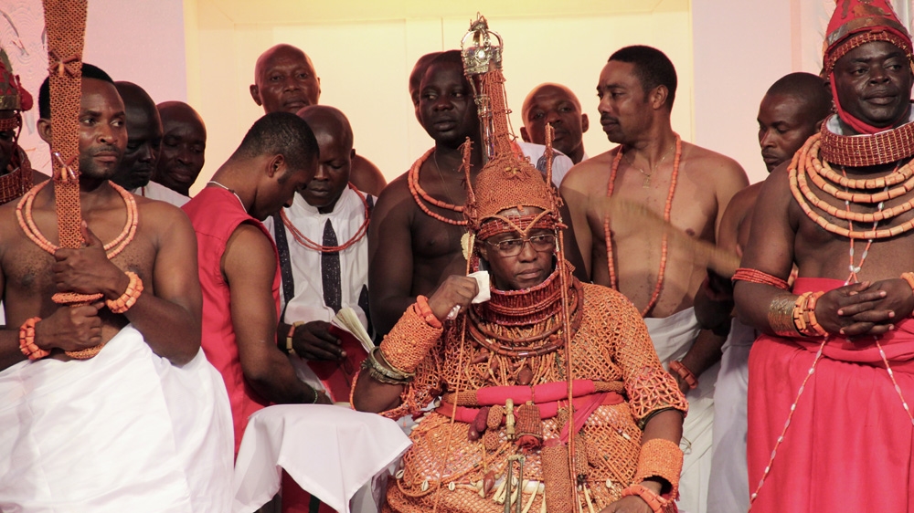 The newly crowned Oba with a handkerchief he placed in front of his mouth, a sign that he does not speak in public regularly, but when he does, his word is final [Femke van Zeijil/Al Jazeera] 