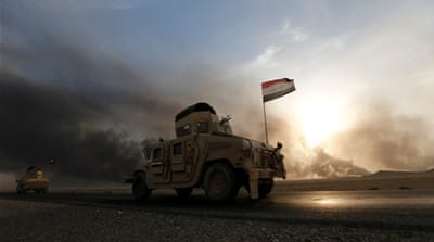 Iraqi army gather after the liberation of a village from Islamic State militants, south of Mosul, during an operation to attack Islamic State militants in Mosul