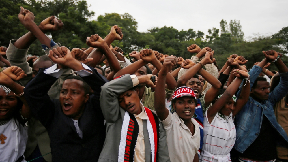 Ethiopian Demonstrators chant slogans while flashing the Oromo protest gesture during Irreecha, the thanksgiving festival