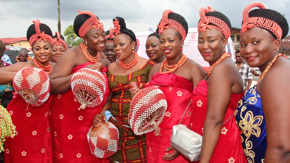 The wives and daughters of the chiefs sing praise to the Oba, one of the few roles women have to play in the 10-day long coronation process [Femke van Zeijil/Al Jazeera] 