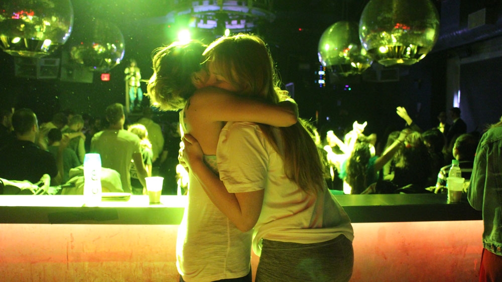 
Daybreakers embrace each other and seek comfort as the reality of an impending Trump presidency is sinking in [Stephanie Ott/ Al Jazeera]
