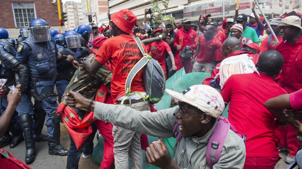 Outside the High Court, demonstrators carried 'Zuma must go' placards. [Herman Verwey/EPA]