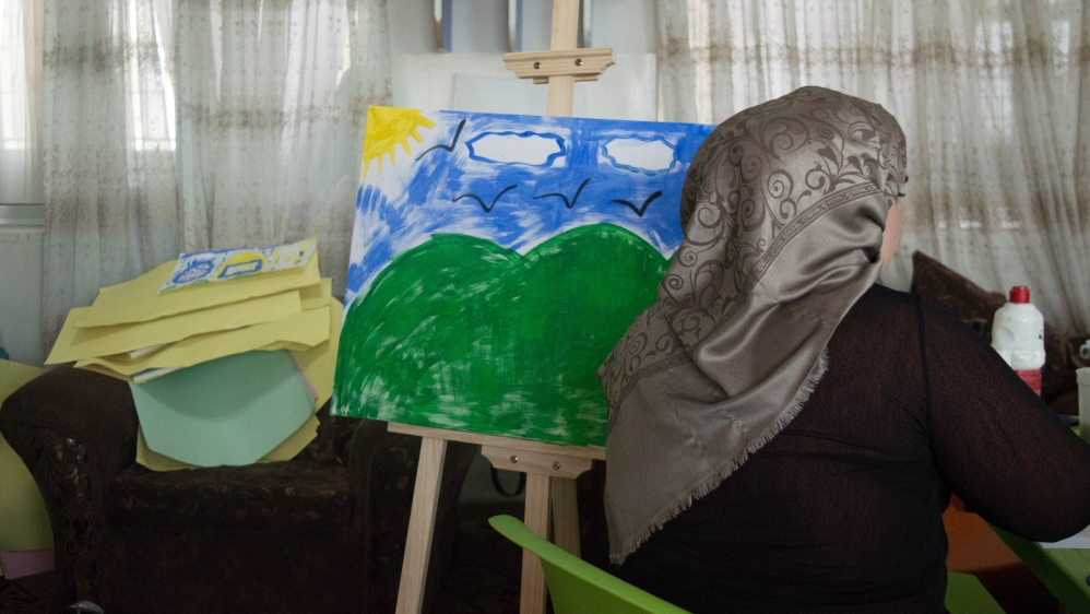 A foster mother adds the finishing touches to her work at the centre [Bethan Staton/Al Jazeera]