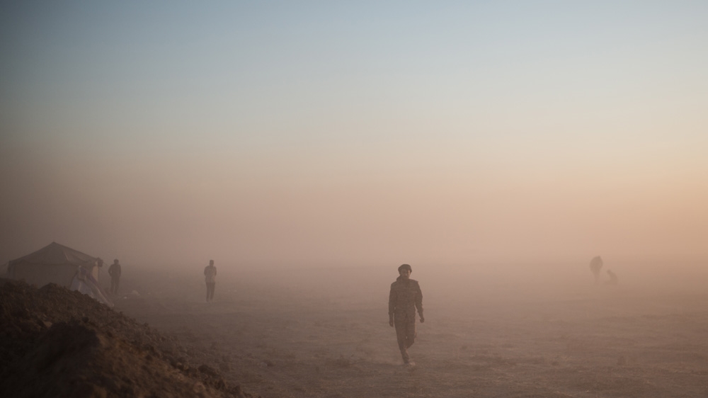 Roads eventually become dry mud and the last 30km to the airport cuts through a virtual moonscape of fine dust  that plumes from wheel arches cutting visibility to metres  [John Beck/AlJazeera]