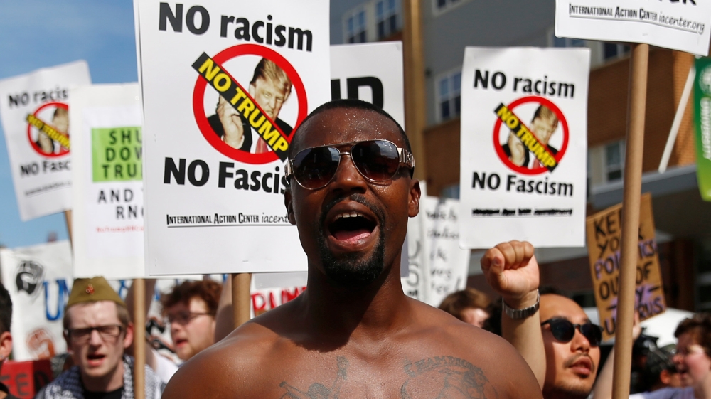 A demonstrator yells during a march by various groups, including "Black Lives Matter" and "Shut Down Trump and the RNC", ahead of the Republican National Convention in Cleveland