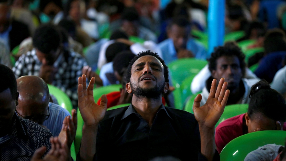 A man attends a prayer session and candle ceremony for protesters who died in the town of Bishoftu a week ago [Reuters]