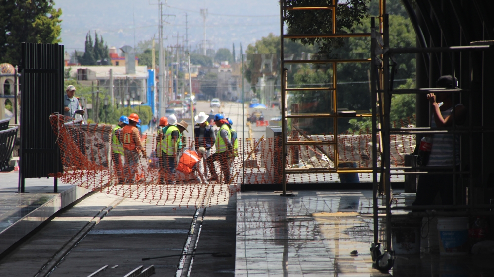 Workers constructing a railway station on top of what archaeologists say is a pre-Columbian platform [Ryan Mallett-Outtrim/Al Jazeera] 