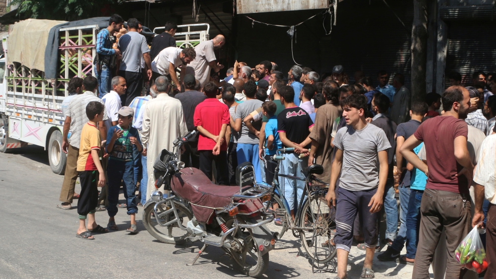 People buy food in Syria''s besieged east Aleppo