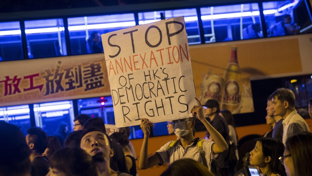 Scuffles broke out and police pepper-sprayed some demonstrators as they marched from Wan Chai district to the city's Central financial district [EPA]