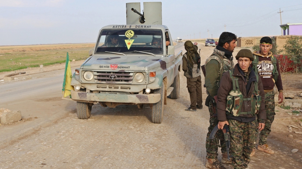 A military vehicle stops at a Kurdish People''s Protection Units and Kurdistan Workers Party fighters checkpoint on the highway connecting the towns of Rabia and Snuny,