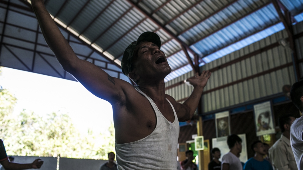 John, one of Pat Jasan's clients, sings before morning mass at the Catholic Rebirth Rehabilitation Centre that is part of the Pat Jasan network [David Shaw/Al Jazeera]