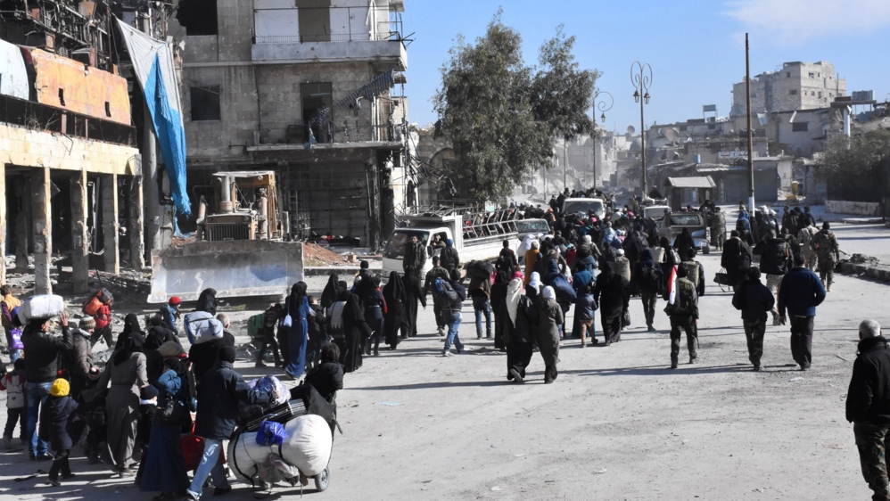 People leave the eastern districts of Aleppo, Syria