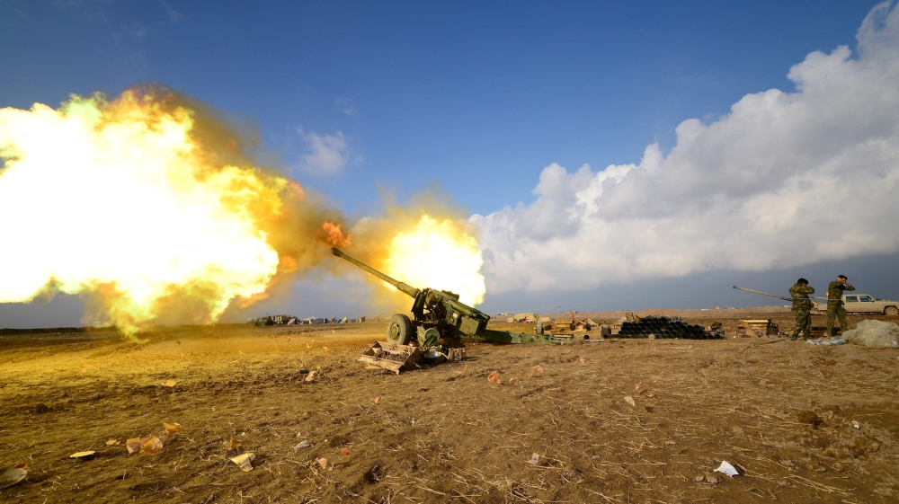 Members of Hashid Shaabi or Popular Mobilization Forces (PMF) fire towards Islamic State militant positions in west of Mosul