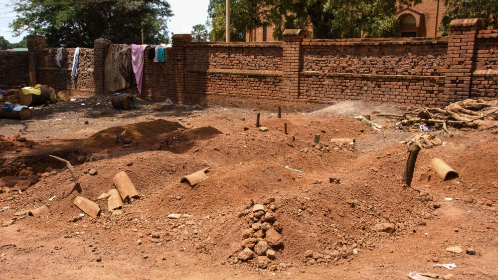 Sixteen people were buried in the grounds of St Mary’s Cathedral compound in Wau after soldiers and armed militia carried out house to house attacks in the town [Richard Nield/Al Jazeera]