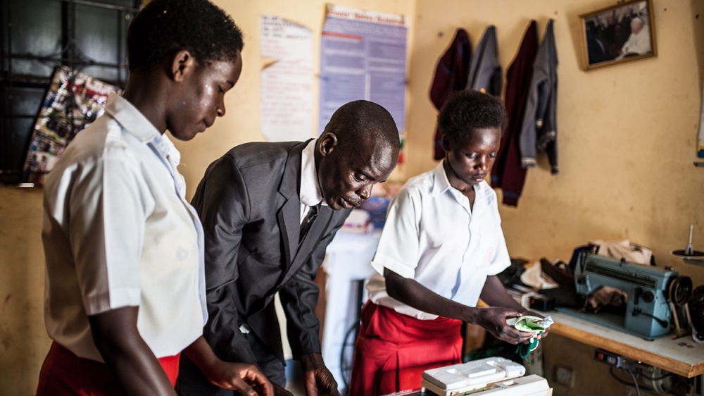 Simon Peter Otoyo teaching knitting to his students at Amor Foundation Vocational Training, Bweyale, Uganda [Aurelie Marrier d'Unienville/Sightsavers/Al Jazeera]
