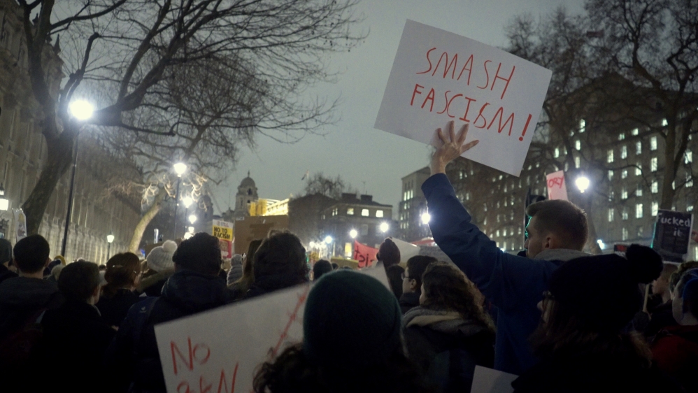 Many placards compared Trump to fascist leaders during the World War II [Shafik Mandhai/Al Jazeera]