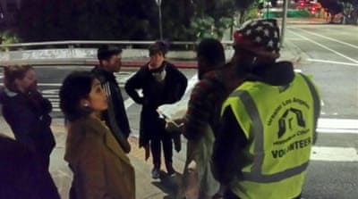 
Volunteer counter Dion Smith, right, says the homelessness crisis in Los Angeles makes his stomach ache [Carla Green/Al Jazeera]
