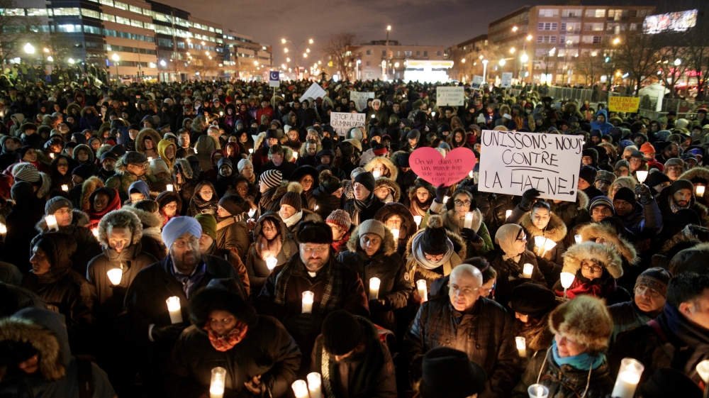 People attend a vigil in support of the Muslim community in Montreal