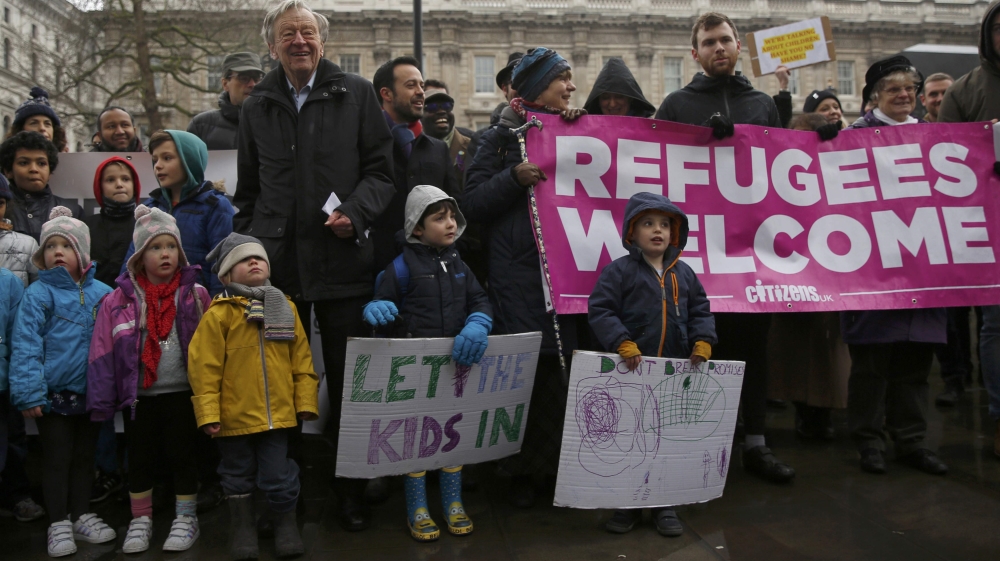 Labour peer Alf Dubs poses with protestors in London as they oppose the closure of a government scheme to bring unaccompanied child refugees to Britain from Europe