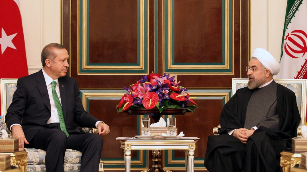 Iranian president Hassan Rowhani speaks with Recep Tayyip Erdogan during their meeting at the presidential palace in Tehran in 2014 [Abedin Taherkenareh/EPA]
