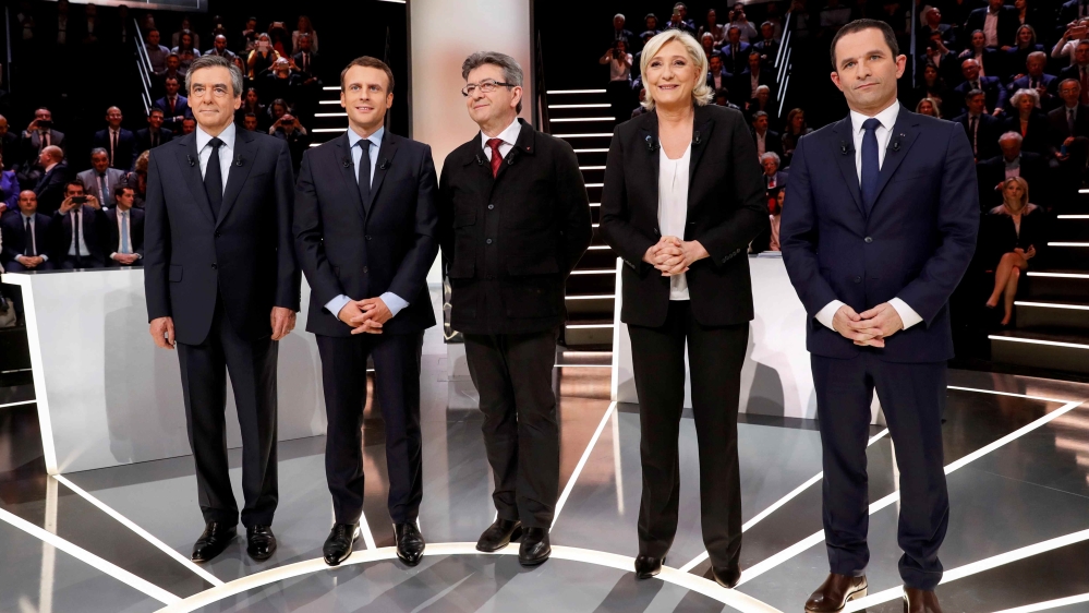 French presidential election candidates (LtoR) Francois Fillon, Emmanuel Macron, Jean-Luc Melenchon, Marine Le Pen and Benoit Hamon, pose before a debate organised by French private TV channel TF1 in