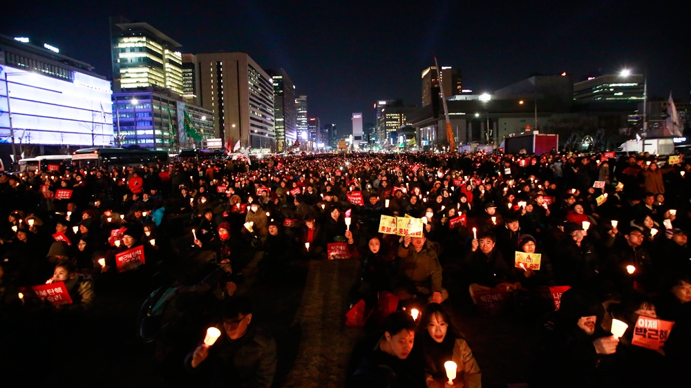 Anti-Park protesters gather on Friday evening to celebrate the ouster of the president [EPA]