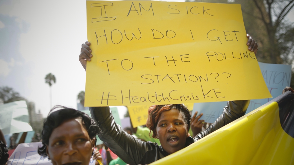
In late February, activists in Nairobi protested against the health ministry demanding better healthcare as the standoff between the ministry and doctors continues. A woman holds a sign referring to the general election which will take place in August [Dai Kurokawa/EPA]
